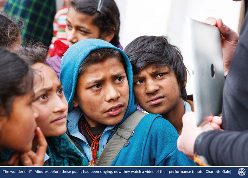 Children looking at an ipad in Nepal